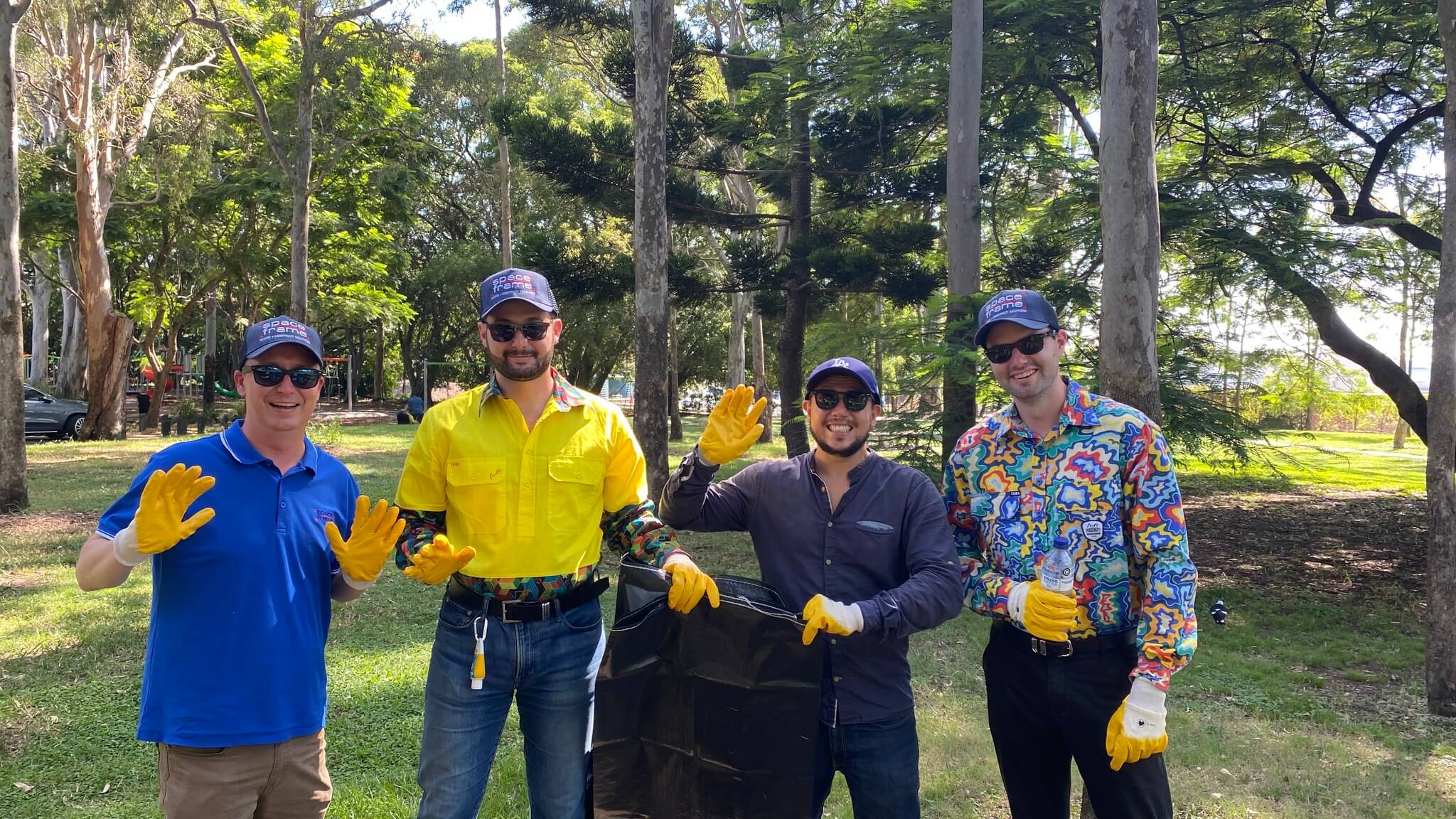 A group of men with gloves and rubbish bags
