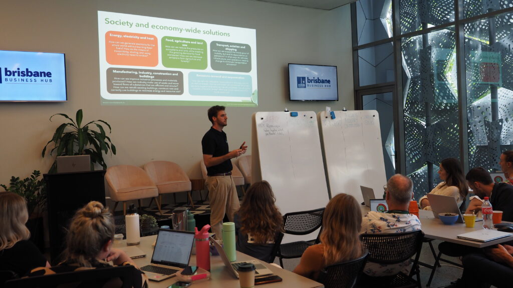 Sustainability training session with instructor presenting to organisational staff about climate solutions.