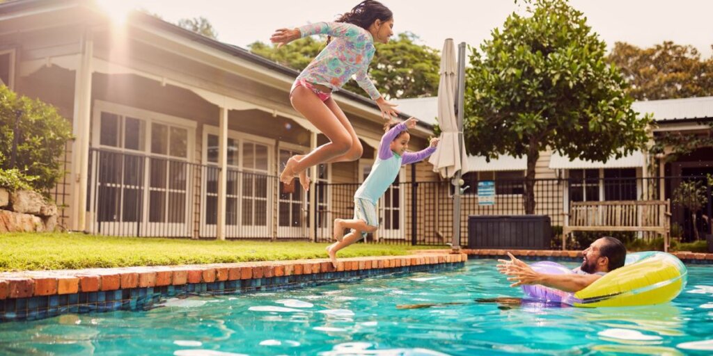 Kids jumping into the pool
